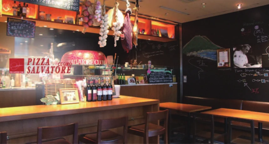照明とオープンキッチンを配した店内